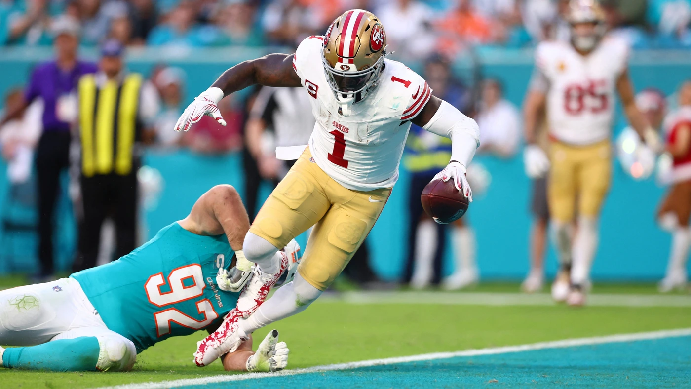 Deebo Samuel Sr. #1 of the San Francisco 49ers scores a touchdown against Zach Sieler #92 of the Miami Dolphins during the second quarter at Hard Rock Stadium on December 22, 2024