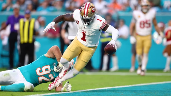 Deebo Samuel Sr. #1 of the San Francisco 49ers scores a touchdown against Zach Sieler #92 of the Miami Dolphins during the second quarter at Hard Rock Stadium on December 22, 2024