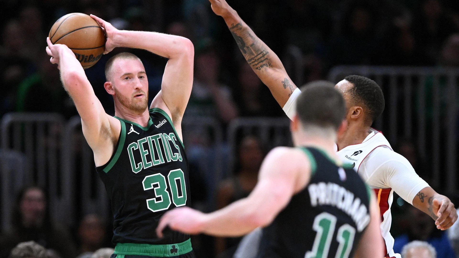 BOSTON, MASSACHUSETTS - FEBRUARY 06: Sam Hauser #30 of the Boston Celtics passes the ball against the Miami Heat during the first half at the TD Garden on February 06, 2026 in Boston, Massachusetts.