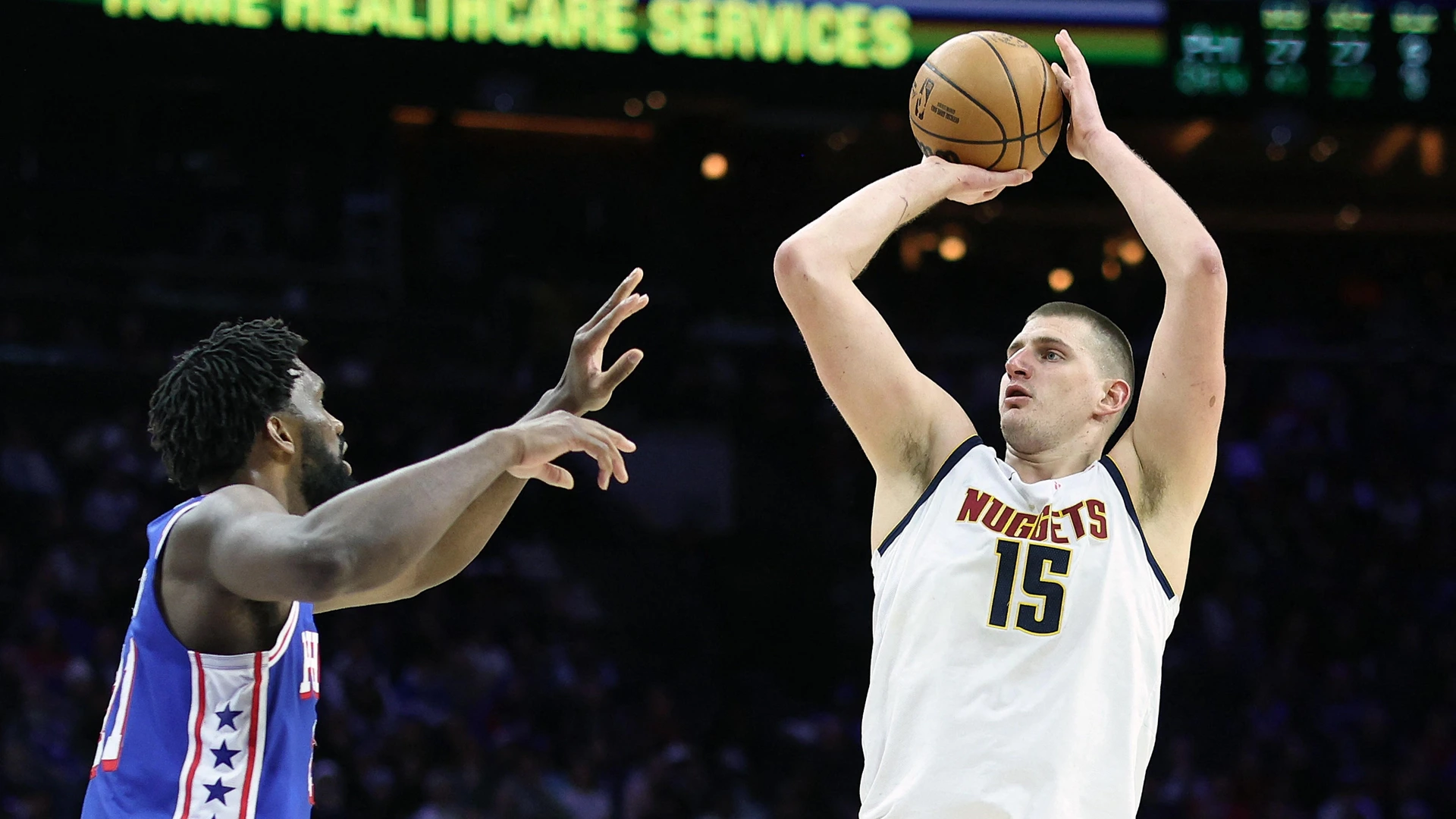 PHILADELPHIA, PENNSYLVANIA - JANUARY 16: Nikola Jokic #15 of the Denver Nuggets shoots over Joel Embiid #21 of the Philadelphia 76ers during the fourth quarter at the Wells Fargo Center on January 16, 2024 in Philadelphia, Pennsylvania.
