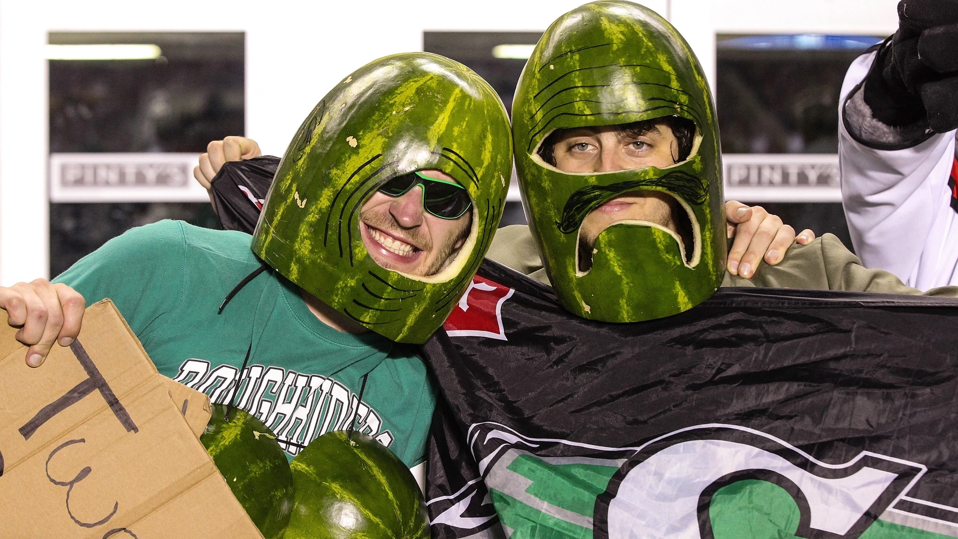 Two fans of the Saskatchewan Roughriders wear watermelons on their heads during a CFL game against the Ottawa Redblacks at TD Place Stadium on August 2, 2014 in Ottawa, Ontario, Canada.