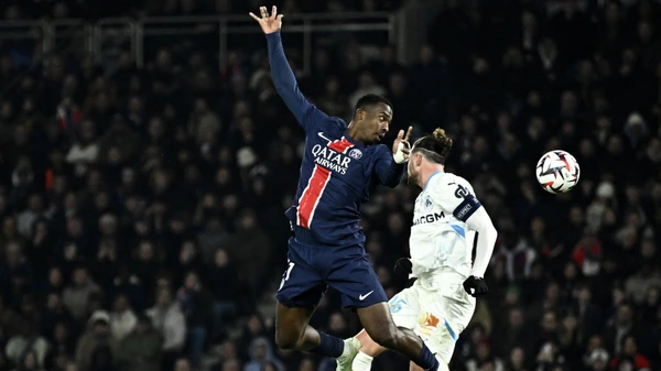 Paris Saint-Germain's #51 Willian Pacho (L) fights for the ball with Marseille's #25 Adrien Rabiot during the French L1 football match between Paris Saint-Germain (PSG) and Olympique de Marseille (OM) on March 16, 2025.