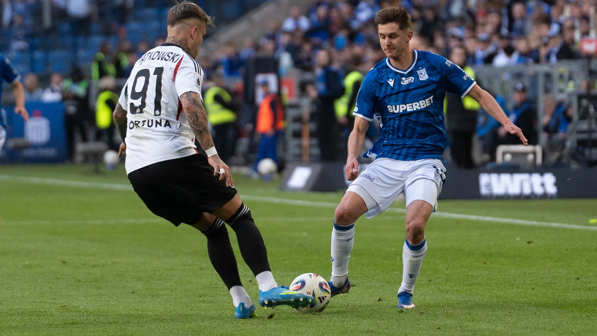 Kamil Piatkowski of Legia Warszawa and Leo Bengtsson of Lech Poznan are seen during the PKO Bank Polski Ekstraklasa match between Legia Warszawa and Lech Poznan at the Enea Stadion in Poznan, Poland, on April 26, 2026. 