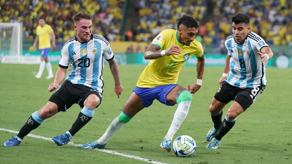 Raphinha C of Brazil vies for the ball with Marcos Acuna R and Alexis Mac Allister of Argentina during the 2026 World Cup qualifier match between Brazil and Argentina at the Maracana stadium in Rio de Janeiro, Brazil, on Nov. 21, 2023.