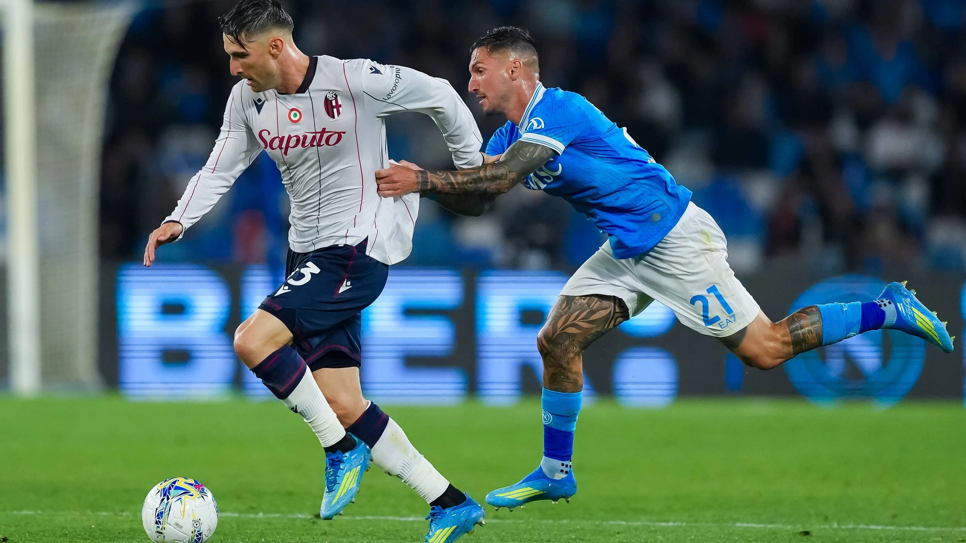 Juan Miranda of Bologna FC and Matteo Politano of SSC Napoli compete for the ball during the serie Serie A Enilive match between SSC Napoli and Bologna FC at Stadio Diego Armando Maradona on May 11, 2026