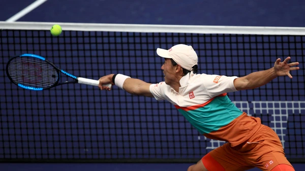INDIAN WELLS, CALIFORNIA - MARCH 12: Kai Nishikori of Japan hits a backhand against Hubert Kurkacz of Poland during their men's singles fourth round match on day nine of the BNP Paribas Open at the Indian Wells Tennis Garden on March 12, 2019