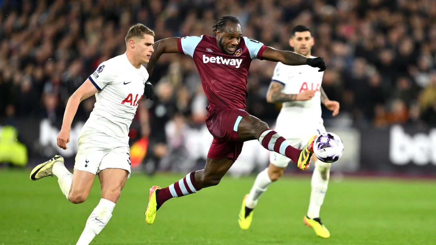 2nd April 2024. West Ham United s Michail Antonio holds off the challenge from Tottenham Hotspur s Micky van de Ven.