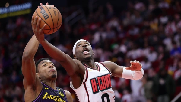 HOUSTON, TEXAS - JANUARY 05: Aaron Holiday #0 of the Houston Rockets shoots the ball against Rui Hachimura #28 of the Los Angeles Lakers during the second half at Toyota Center on January 05, 2025 in Houston, Texas.