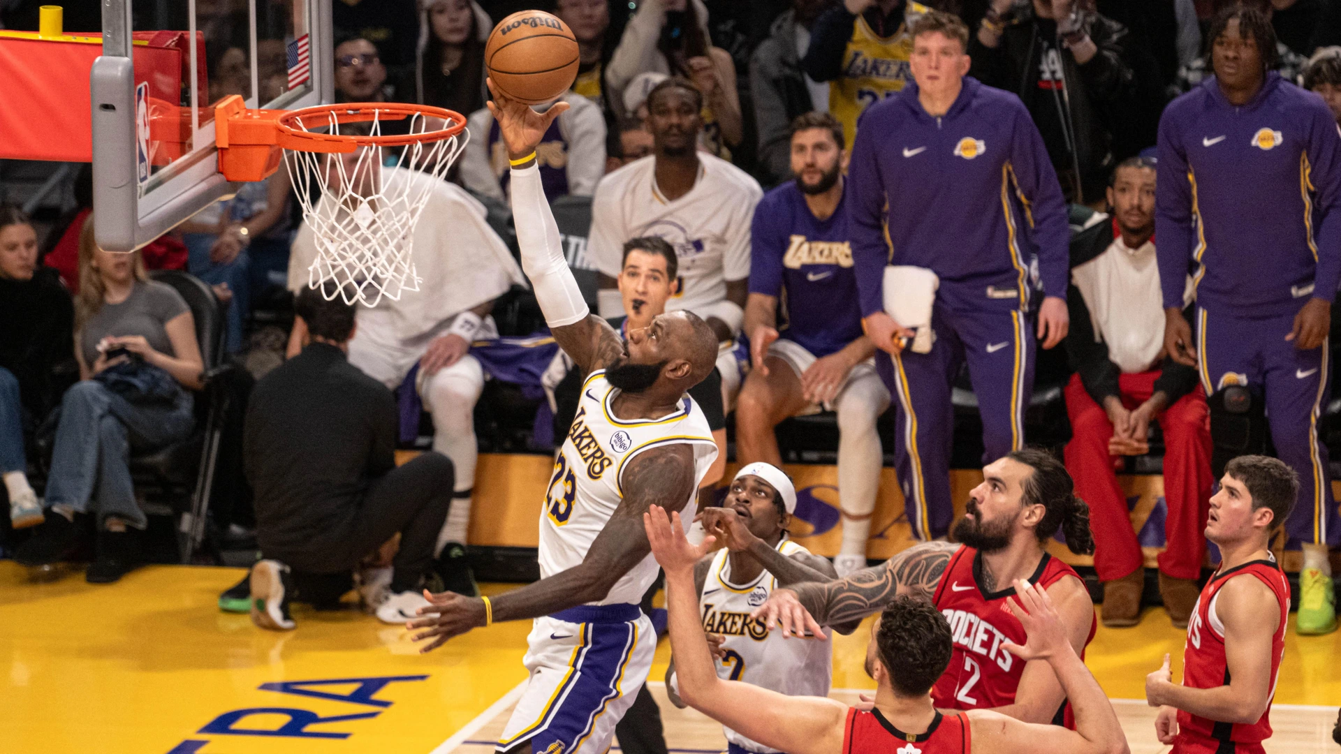 Lebron James (23) of the Los Angeles Lakers attempts a lay up over Rockets defenders during the NBA basketball game between LA Lakers and Houston Rockets at Crypto.com Arena in Los Angeles, United States on December 25, 2025.