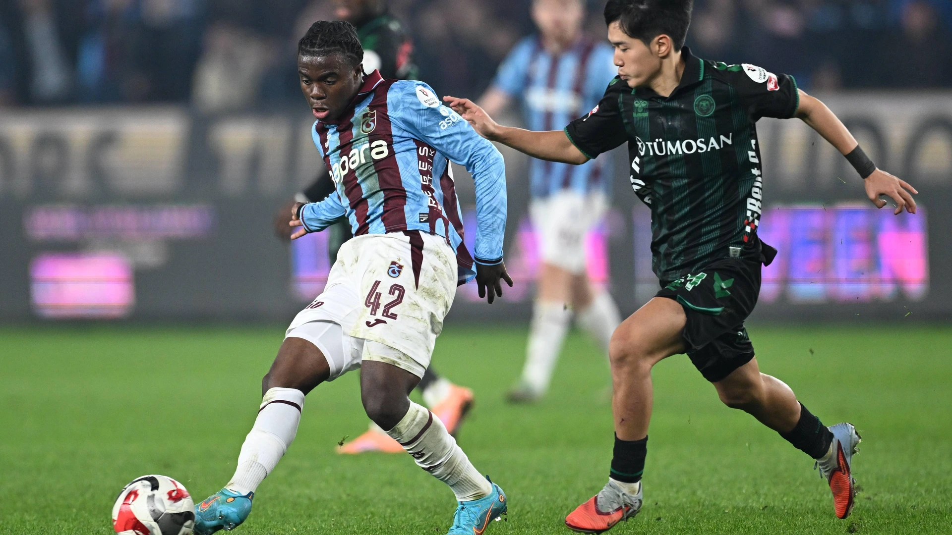 Christ Inao Oulai L of Trabzonspor in action against Jin-ho Jo R of TUMOSAN Konyaspor during the Turkish Super Lig week 14 match between Trabzonspor and TUMOSAN Konyaspor at Papara Park in Trabzon, Turkiye, on November 29, 2025.