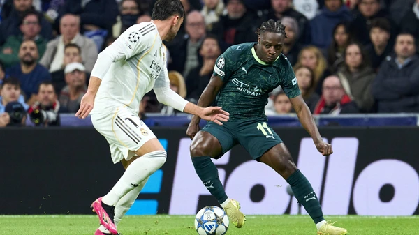Jeremy Doku of Manchester City FC battles for the ball with Raul Asencio of Real Madrid CF during the UEFA CHAMPIONS LEAGUE match between Real Madrid CF and Manchester City FC at Bernabeu stadium on December 10, 2025.