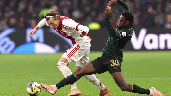 Mika Godts of AFC Ajax with Jordan Lotomba of Feyenoord Rotterdam during the match AFC Ajax Amsterdam vs Feyenoord Rotterdam at the Johan Cruijff ArenA for the Dutch Eredivisie season 2025-2026 in AMSTERDAM, Netherlands on 14 december 2025