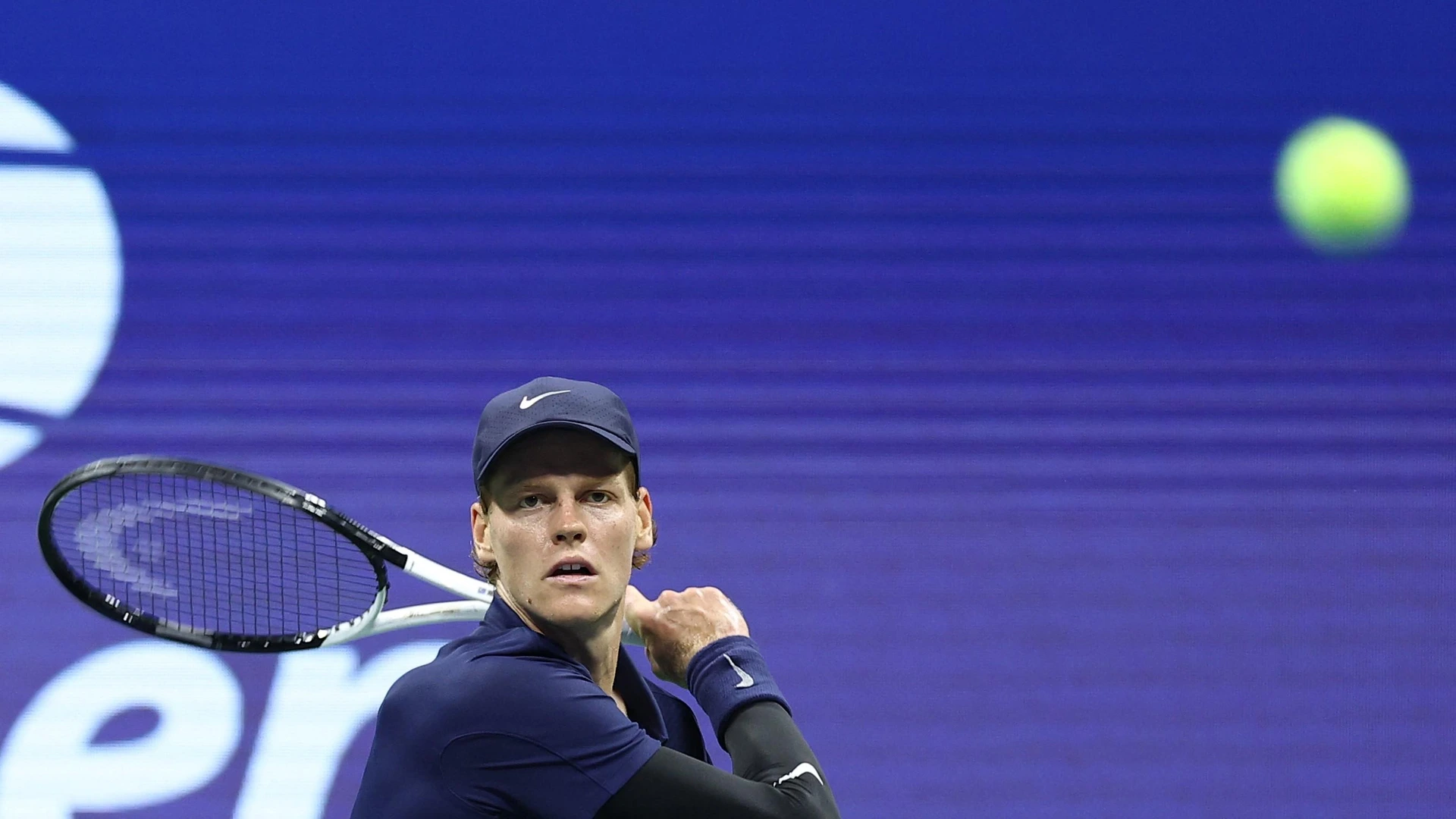 Italy's Jannik Sinner returns the ball to Canada’s Felix Auger-Aliassime during their men's singles semifinal tennis match on day thirteen of the US Open tennis tournament a in New York City, on September 5, 2025.