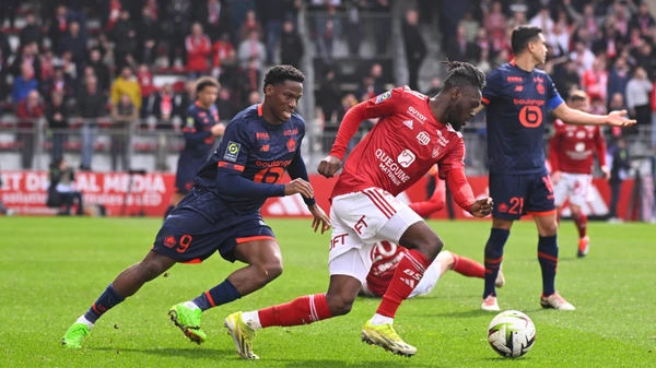 Bradley LOCKO  2 - Brest  and Jonathan David  9 - Lille  during the Ligue 1 match between Stade Brestois 29 and Lille OSC at Stade Francis Le Ble on march 17, 2024 in Brest, France.