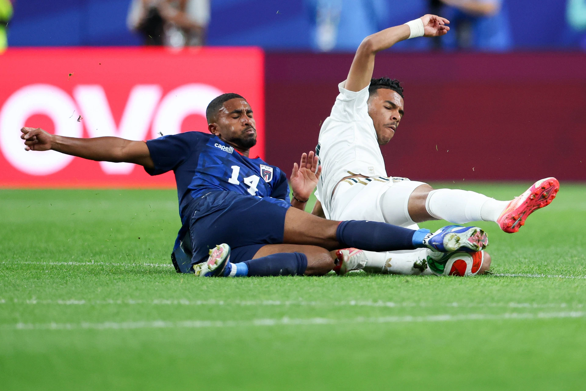 HOUSTON, TX - JUNE 26: Deroy Duarte 14 of Cabo Verde and Musab al-Juwayr 7 of Saudi Arabia slide to try and control the loose ball during the FIFA World Cup, WM, Weltmeisterschaft, Fussball 2026 Gr...