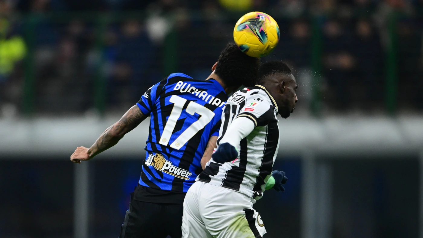 FC Internazionale v Udinese Calcio - Coppa Italia Tajon Buchanan of Inter Milan and Hassane Kamara of Udinese Calcio battle for the ball during the Coppa Italia Frecciarossa match between Inter Milan and Udinese Calcio on December 19, 2024.