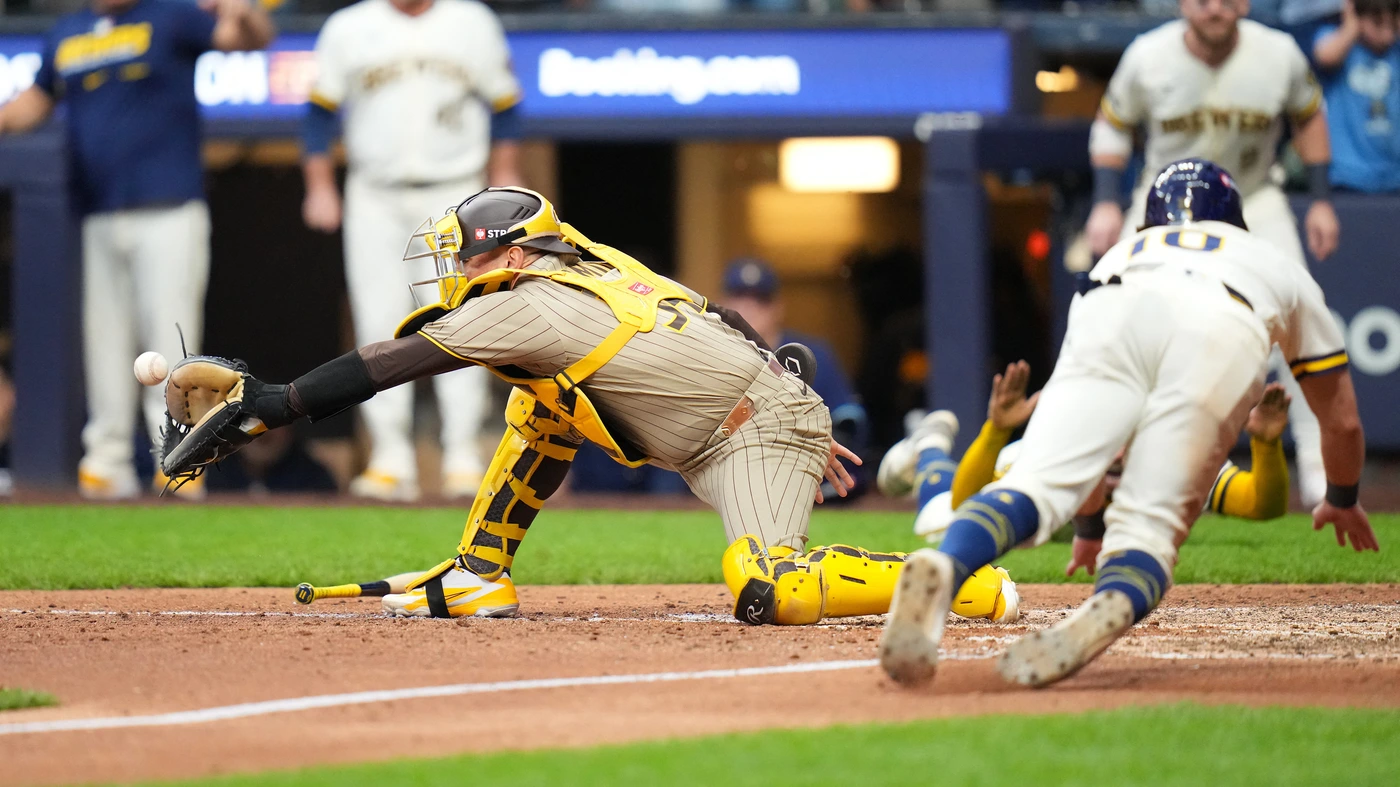Sal Frelick #10 of the Milwaukee Brewers slides into home plate past Freddy Fermin #54 of the San Diego Padres to score the game-winning run during the ninth inning on a hit by Jackson Chourio in game two of the National League Division Series at American Family Field on October 04, 2026