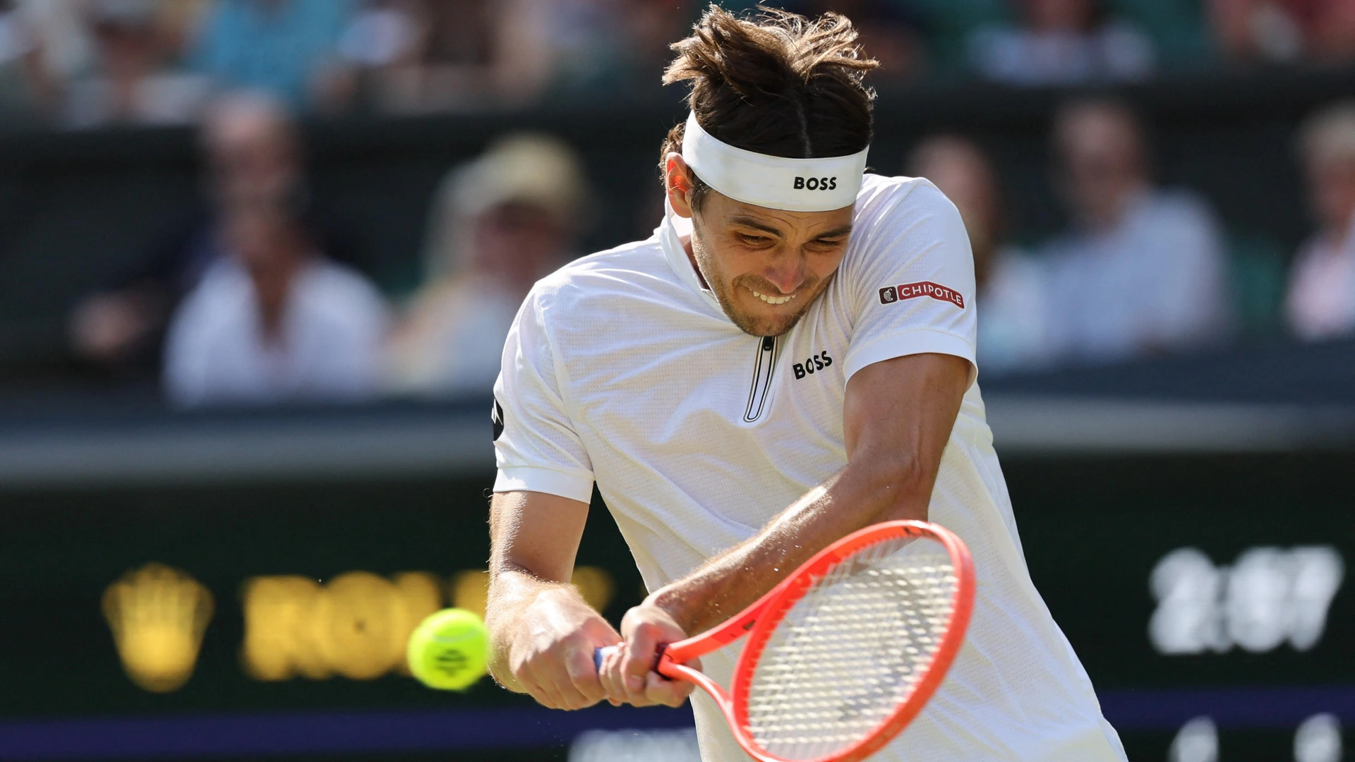 Taylor Fritz of the United States returns the ball to Alejandro Davidovich Fokina of Spain during the men's singles third-round match on day five of the Wimbledon Championships  on Friday, July 4, 2025.
