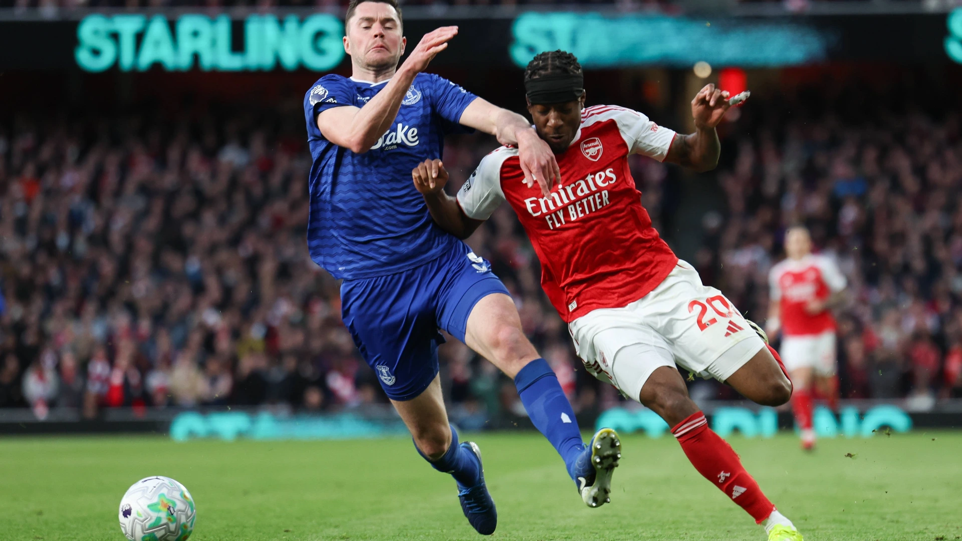 Everton defender Michael Keane challenges Arsenal forward Noni Madueke during the Arsenal v Everton Premier League match at the Emirates Stadium, London, England on 14 March 2026