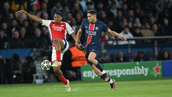Achraf Hakimi of PSG competes with Myles Lewis-Skelly of Arsenal during the UEFA Champions League second leg semi-final match between PSG and Arsenal at Parc des Princes stadium in Paris, France on May 7, 2025.