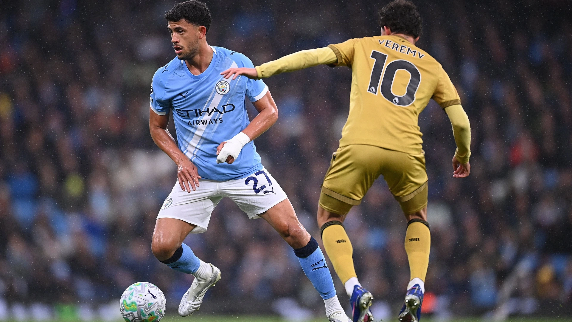 Matheus Nunes of Manchester City runs with the ball whilst under pressure from Yeremi Pino of Crystal Palace during the Manchester City v Crystal Palace Premier League match on 13 May 2026 
