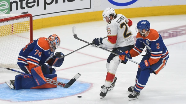 Evan Bouchard #2 of the Edmonton Oilers lifts the stick of Carter Verhaeghe #23 of the Florida Panthers preventing him from shooting against Stuart Skinner #74 during the third period Game Two of the 2025 Stanley Cup Final on June 6, 2025.