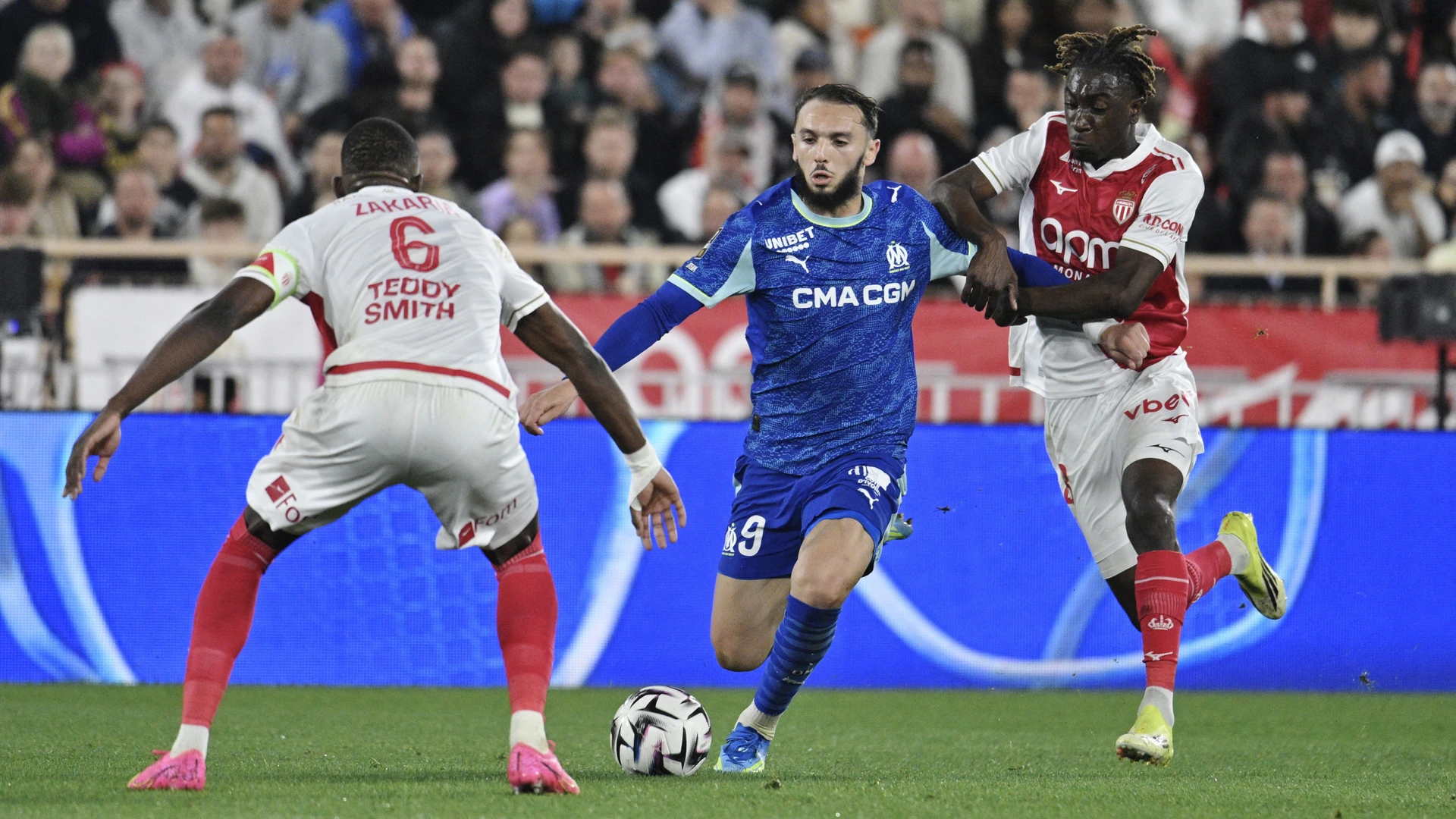 Marseille's Algerian forward #09 Amine Gouiri (C) fights for the ball with Monaco's French midfielder #28 Mamadou Coulibaly (R) and Monaco's Swiss midfielder #06 Denis Zakaria (L) during the French L1 football match between Monaco (ASM) and Olympique de Marseille (OM) at the Louis II Stadium in Monaco on April 5, 2026.