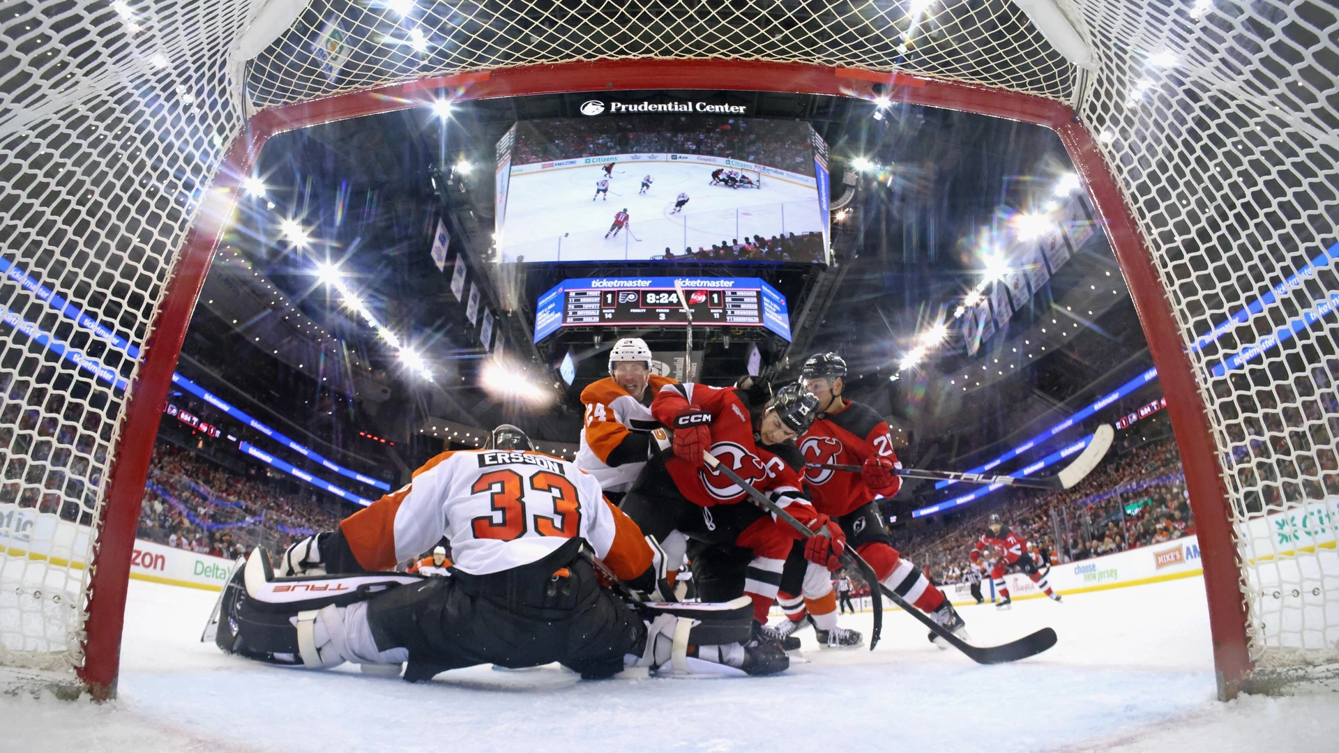 Nico Hischier #13 of the New Jersey Devils skates in his 500th NHL game against Samuel Ersson #33 of the Philadelphia Flyers at Prudential Center on January 18, 2025 in Newark, New Jersey. The Flyers defeated the Devils 3-1.