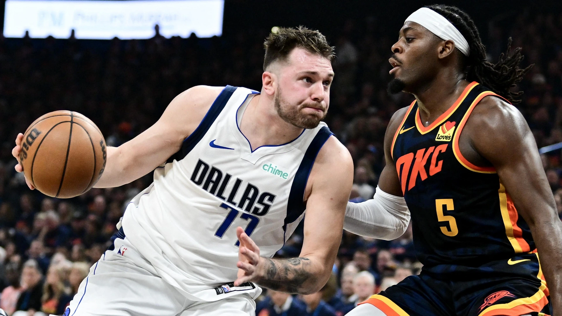 Luka Doncic #77 of the Dallas Mavericks drives to the basket against Luguentz Dort #5 of the Oklahoma City Thunder during the second quarter in Game Five of the Western Conference Second Round Playoffs at Paycom Center on May 15, 2024