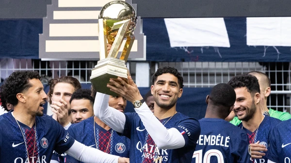 Achraf Hakimi of Paris Saint-Germain celebrates with the French Ligue 1 trophy after winning the championship ahead of the French L1 football match between Paris FC and Paris Saint-Germain