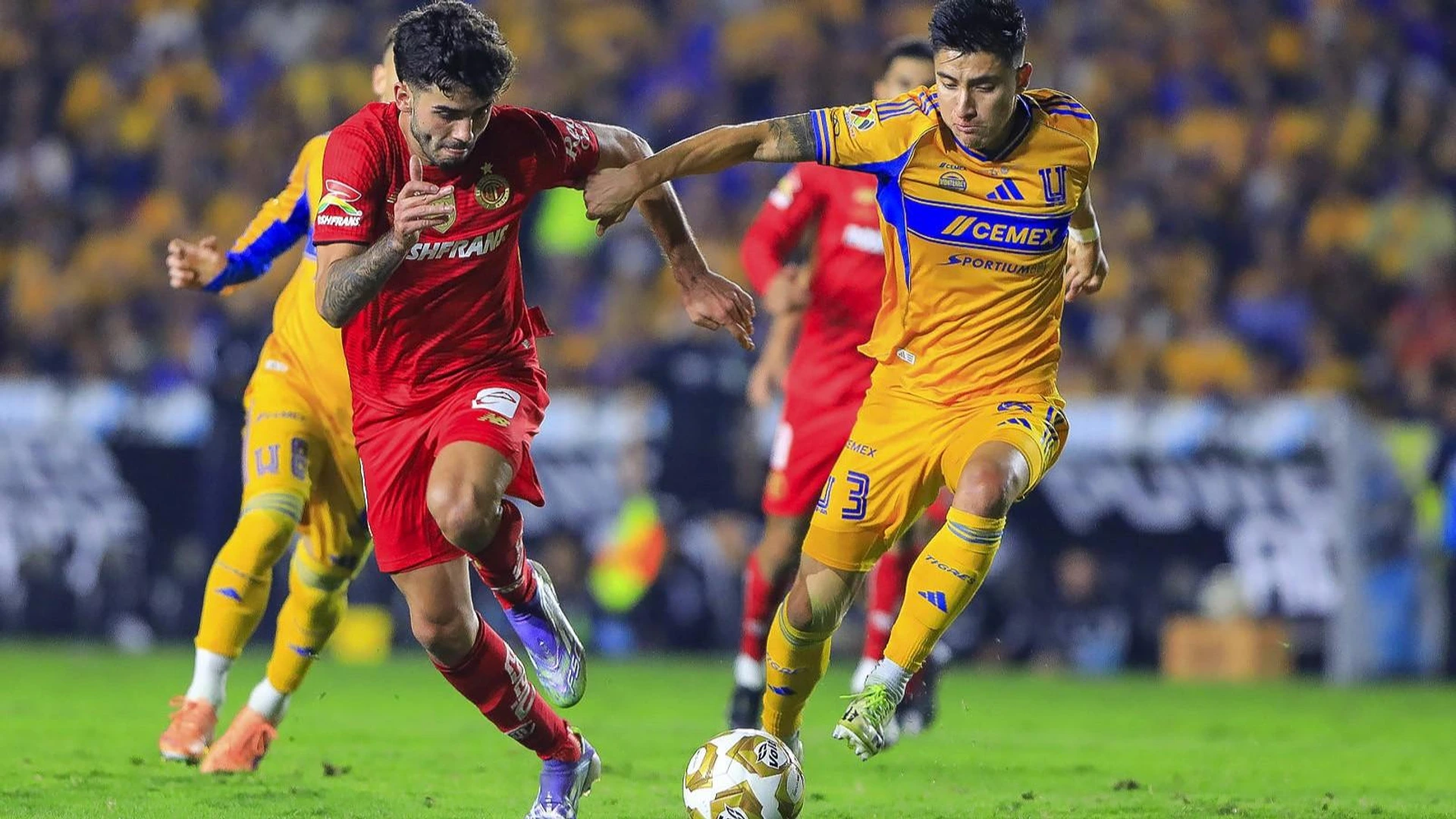 Santiago Simon 19 of Diablos Rojos del Toluca and Marco Farfan 3 of Tigres UANL, during final game of the Torneo de Apertura 2025 of the BBVA Liga MX.