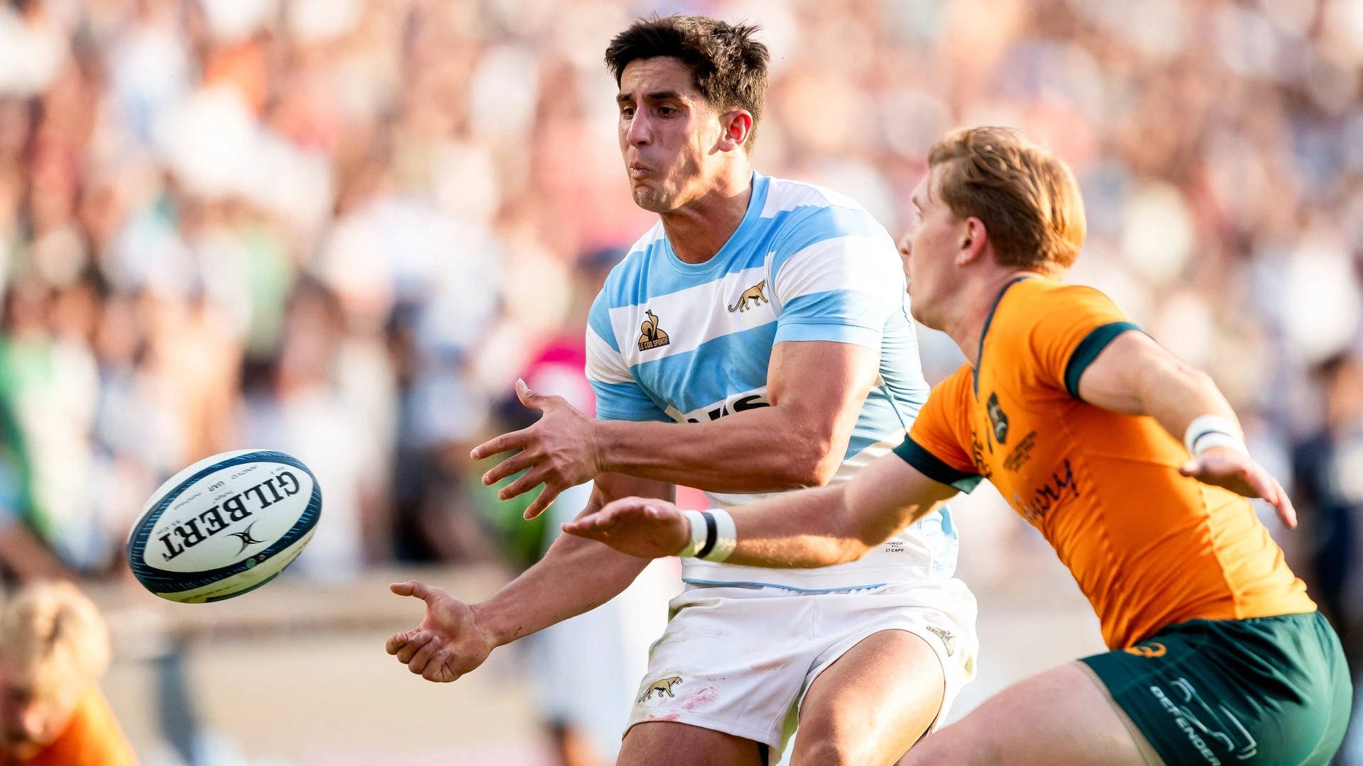 Argentina's Los Pumas centre Lucio Cinti (L) is challenged by Australia's Wallabies wing Max Jorgensen as he passes the ball during the Rugby Championship match between Argentina and Australia at Brigadier General Estanislao Lopez Stadium in Santa Fe, Santa Fe Province, Argentina, on September 07, 2024.