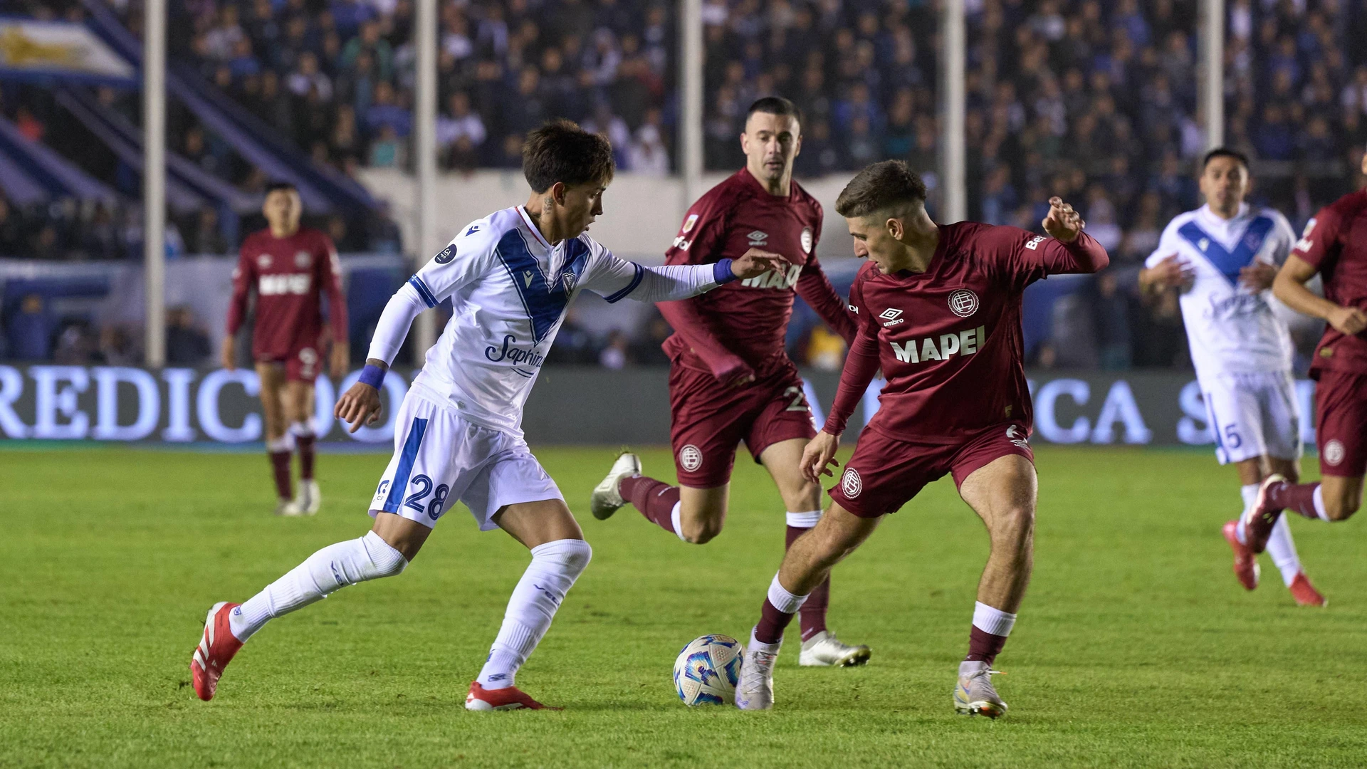 Maher Carrizo of Velez Sarsfield fights for the ball against Sasha Marcich of Lanus during a Copa Argentina match between Velez Sarsfield and Lanus at Estadio Nuevo Francisco Urbano on May 21, 2025 in Buenos Aires, Argentina