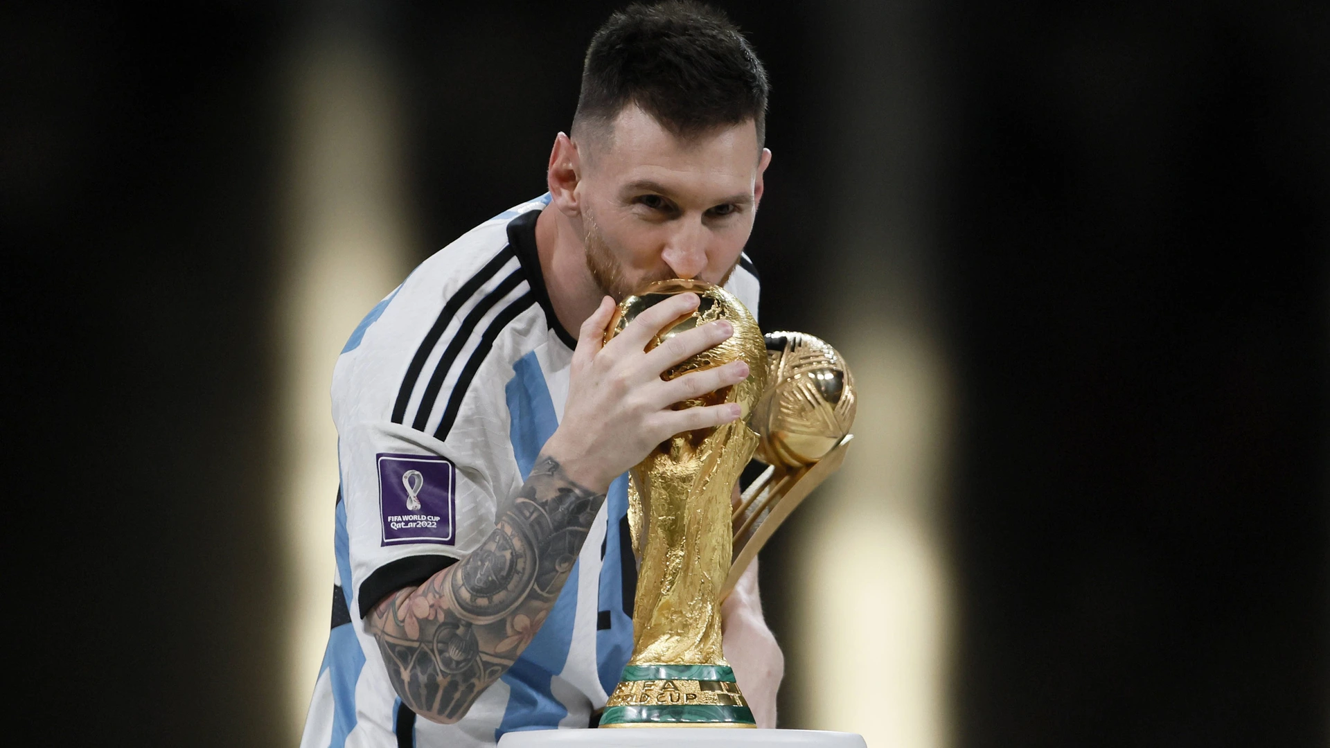 ionel Messi of Argentina kisses the World Cup trophy after the FIFA World Cup Qatar 2022 Final match between Argentina and France at Lusail Stadium on December 18, 2022 in Lusail City, Qatar