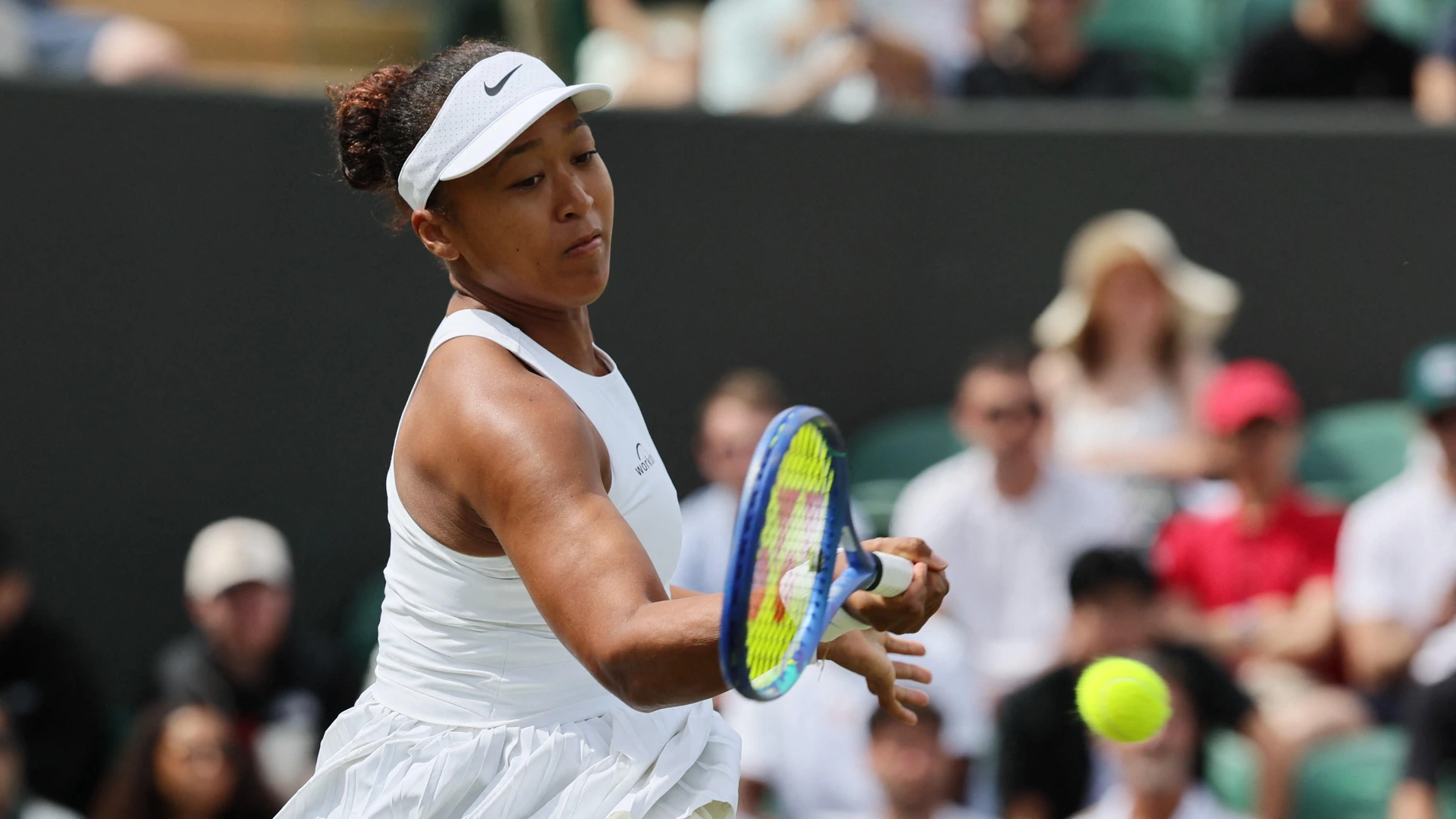Naomi Osaka of Japan returns the ball to Anastasia Pavlyuchenkova of Russia during the women's singles second-round match on day five of the Wimbledon Championships at the All England Lawn Tennis and Croquet Club in London, on Friday, July 4, 2025.