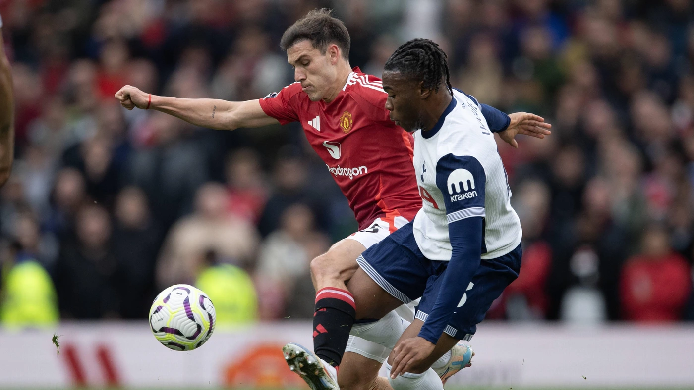 Dejan Kulusevski 21 of Tottenham Hotspur and Lisandro Martinez 6 of Manchester United challenge for the ball during the Premier League match between Manchester United and Tottenham Hotspur at Old Trafford, Manchester, England on 29 September 2024.