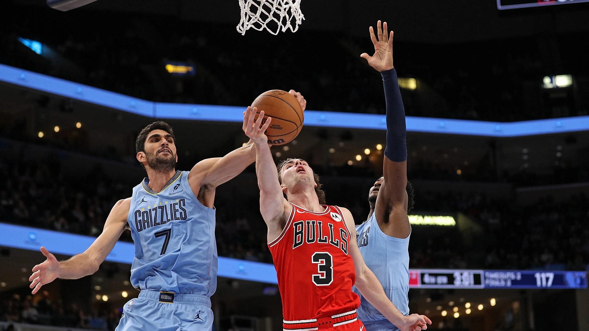 MEMPHIS, TENNESSEE - OCTOBER 28: Josh Giddey #3 of the Chicago Bulls goes to the basket and gets his shot blocked by Santi Aldama #7 of the Memphis Grizzlies during the second half at FedExForum on October 28, 2024 in Memphis, Tennessee.