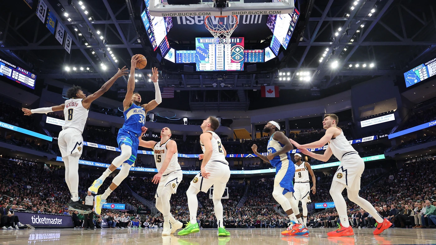 MILWAUKEE, WISCONSIN - FEBRUARY 12: Giannis Antetokounmpo #34 of the Milwaukee Bucks drives to the basket against Nikola Jokic #15 of the Denver Nuggets during a game at Fiserv Foru