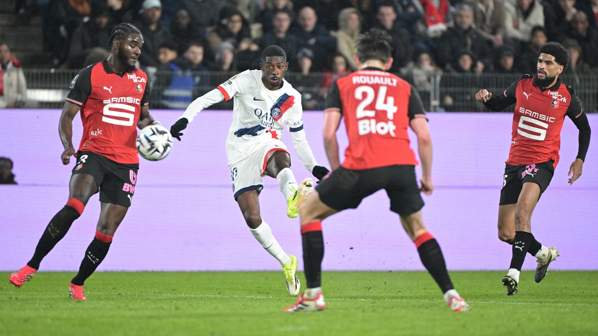 Paris Saint-Germain's French forward #10 Ousmane Dembele (C-L) shoots the ball despite Rennes' French defender #03 Lilian Brassier (L) during the French L1 football match between Stade Rennais FC and Paris Saint-Germain (PSG) on February 13, 2026.