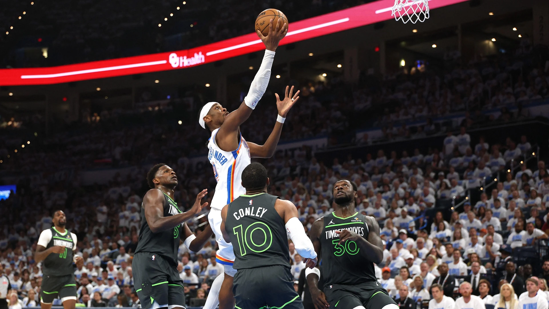 Shai Gilgeous-Alexander #2 of the Oklahoma City Thunder drives to the basket against Mike Conley #10 of the Minnesota Timberwolves during the second quarter in Game One of the Western Conference Finals of the 2025 NBA Playoffs on May 20, 2025