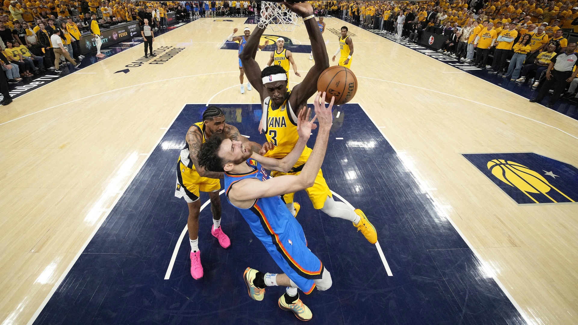 Chet Holmgren #7 of the Oklahoma City Thunder attempts to shoot the ball against Thomas Bryant #3 and Obi Toppin #1 of the Indiana Pacers during the second half in Game Three of the 2025 NBA Finals at Gainbridge Fieldhouse on June 11, 2025