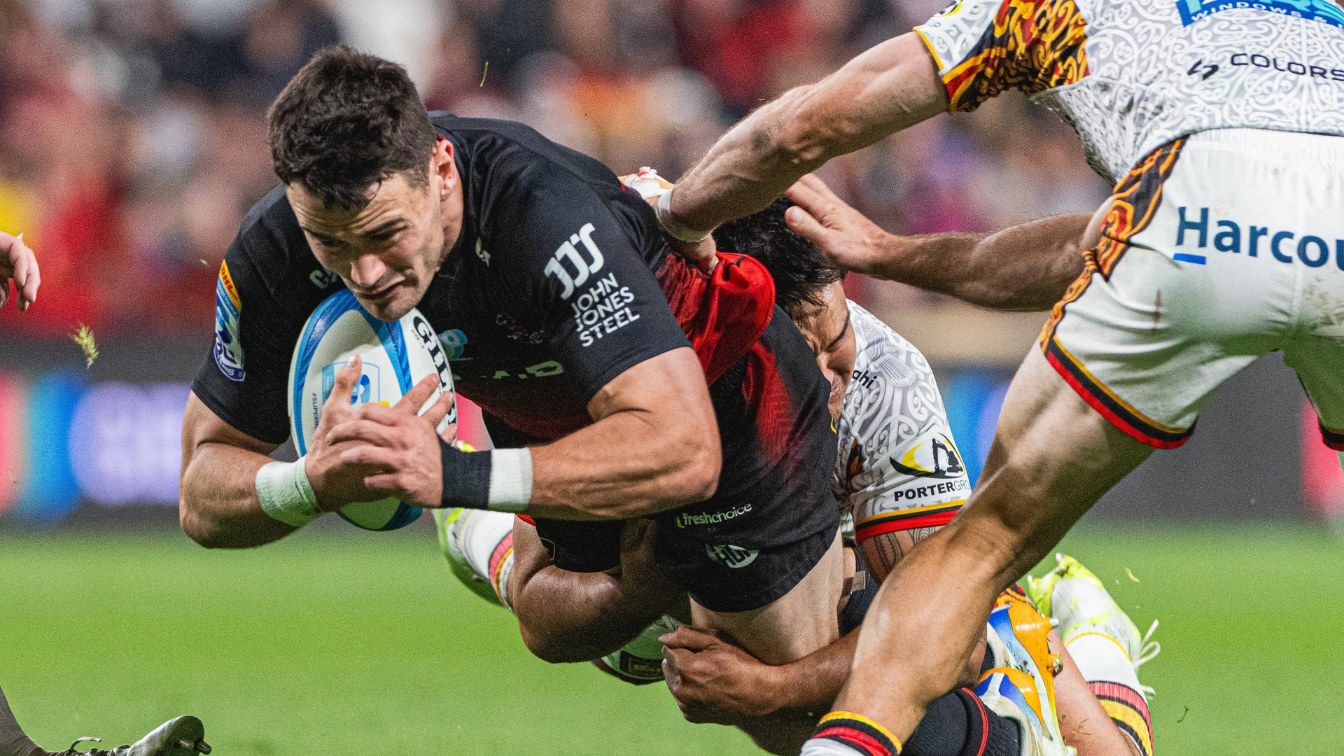 May 22nd, 2026, Christchurch, Christchurch City, New Zealand: Crusaders player Will Jordan centre dives over after being tackled by a Chiefs player during the Super Rugby Pacific Round 15 fixture between the Crusaders and Chiefs at the One NZ Stadium in Christchurch New Zealand