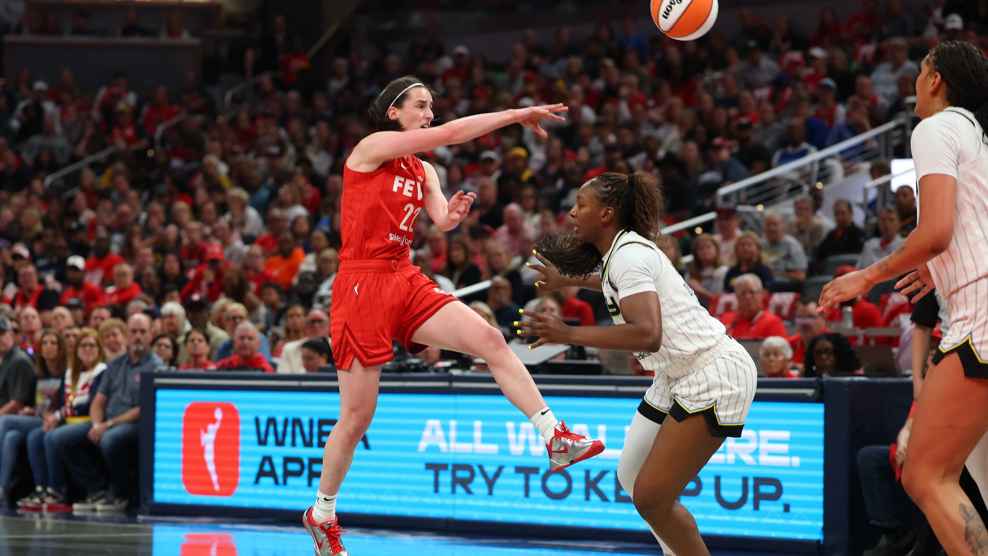 INDIANAPOLIS, INDIANA - MAY 17: Caitlin Clark #22 of the Indiana Fever passes over Michaela Onyenwere #12 of the Chicago Sky during the first half during the Fever's home opener at Gainbridge Fieldhouse on May 17, 2025 in Indianapolis, Indiana. 