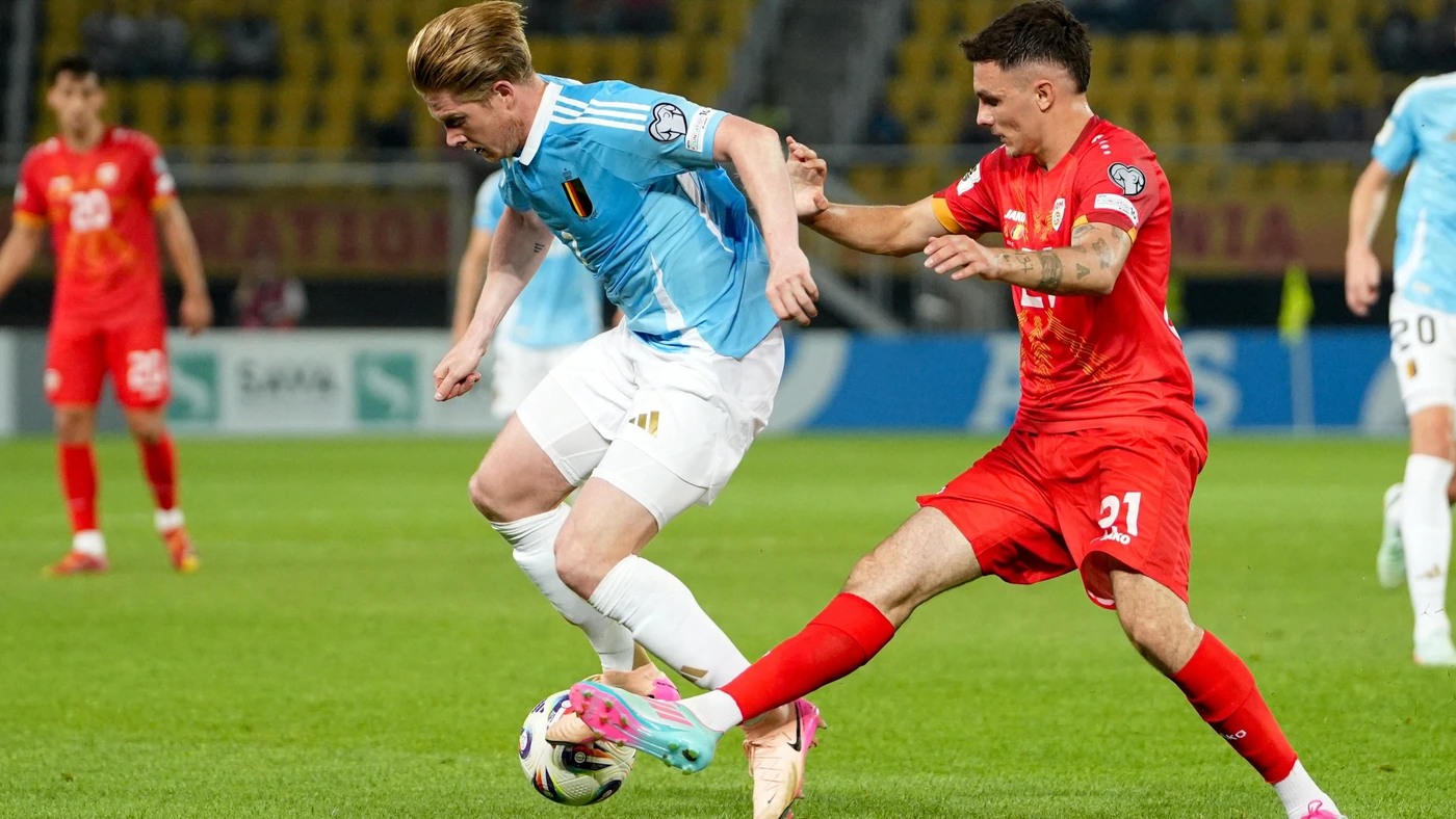Kevin De Bruyne (L) fights for the ball with North Macedonia 's midfielder #21 Jani Atanasov during the FIFA World Cup 2026 European Group J qualification match between North Macedonia and Belgium, in Skopje, on June 6, 2025.