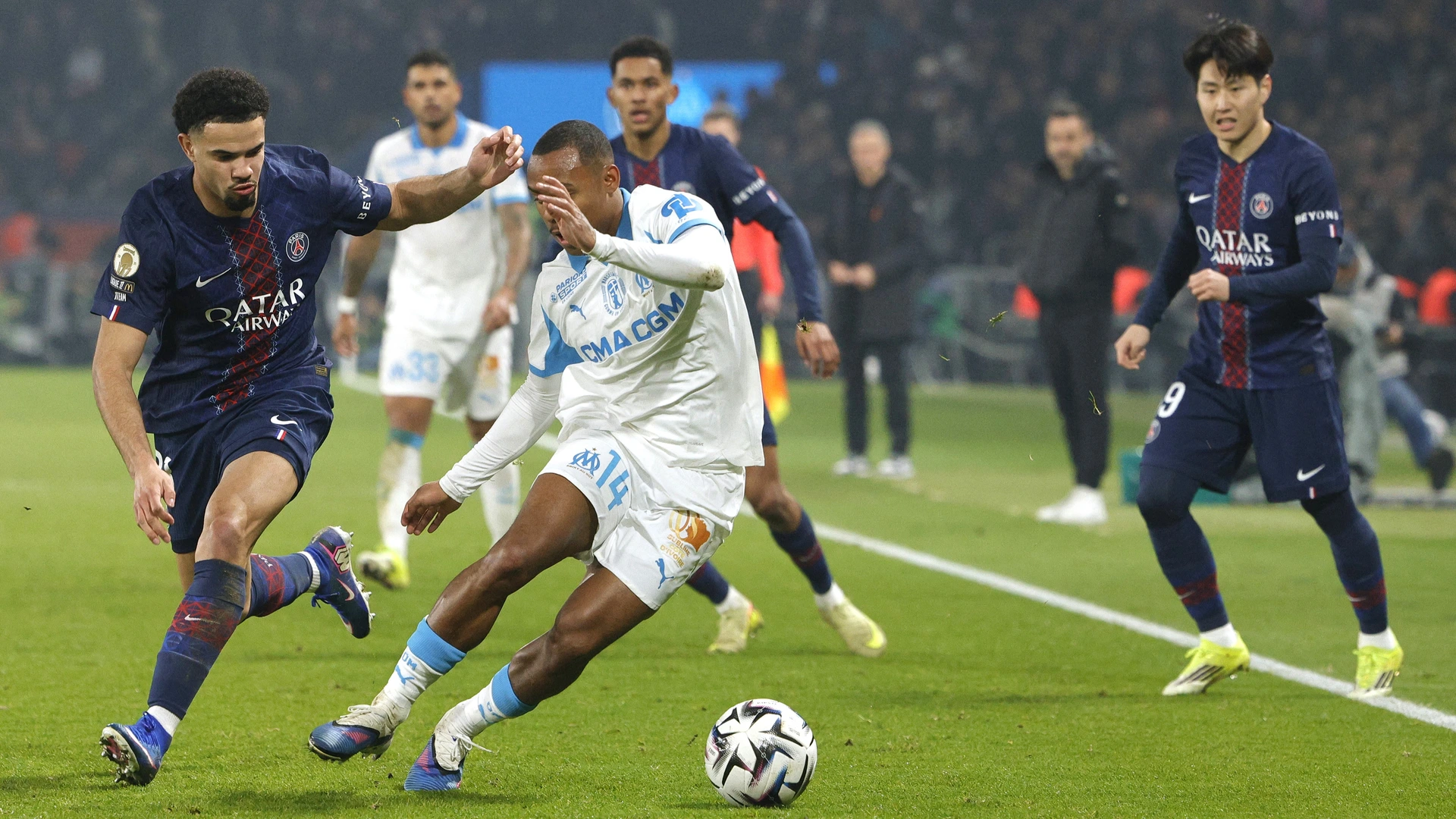 Paris Saint-Germain's French midfielder #33 Warren Zaire-Emery (L) and Marseille's Brazilian forward #14 Igor Paixao (C) fight for the ball during the French L1 football match between Paris Saint-Germain (PSG) and Olympique de Marseille (OM) at the Parc des Princes stadium in Paris on February 8, 2026.