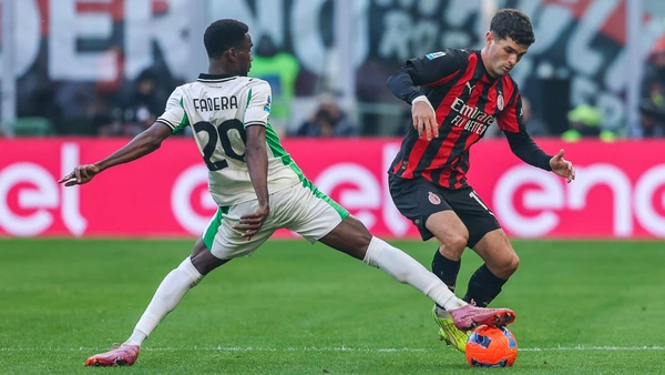 Christian Pulisic of AC Milan competes for the ball with Alieu Fadera of US Sassuolo during Serie A 2025/26 football match between AC Milan and US Sassuolo at San Siro Stadium in Milan Italy on 14 December 2025.