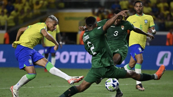 Brazil's forward Richarlison (L) strikes the ball amid Bolivia's defender Jairo Quinteros (R) and defender Diego Medina during the 2026 FIFA World Cup South American qualifiers football match between Brazil and Bolivia on September 8, 2023.