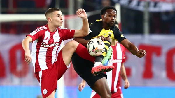 CHRISTOS MOUZAKITIS of Olympiacos FC in action against LEVI GARCIA of AEK FC during the SuperLeague pregular season soccer match between Olympiacos FC and AEK FC held at G.Karaiskakis Stadium in Piraeus, Greece, 24 November 2024.
