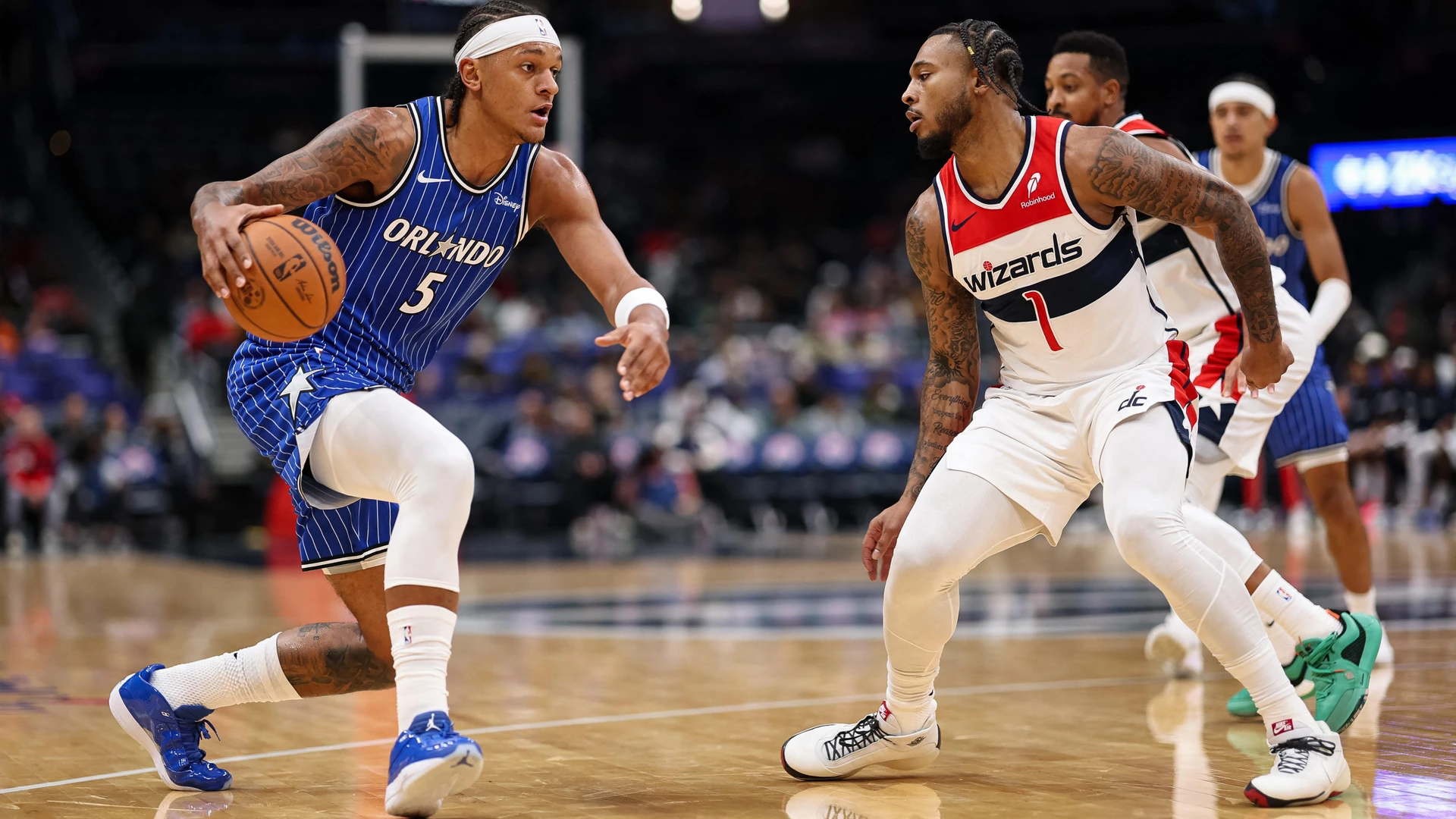 WASHINGTON, DC - NOVEMBER 01: Paolo Banchero #5 of the Orlando Magic drives to the basket against Cam Whitmore #1 of the Washington Wizards during the first half at Capital One Arena on November 1, 2025 in Washington, DC.