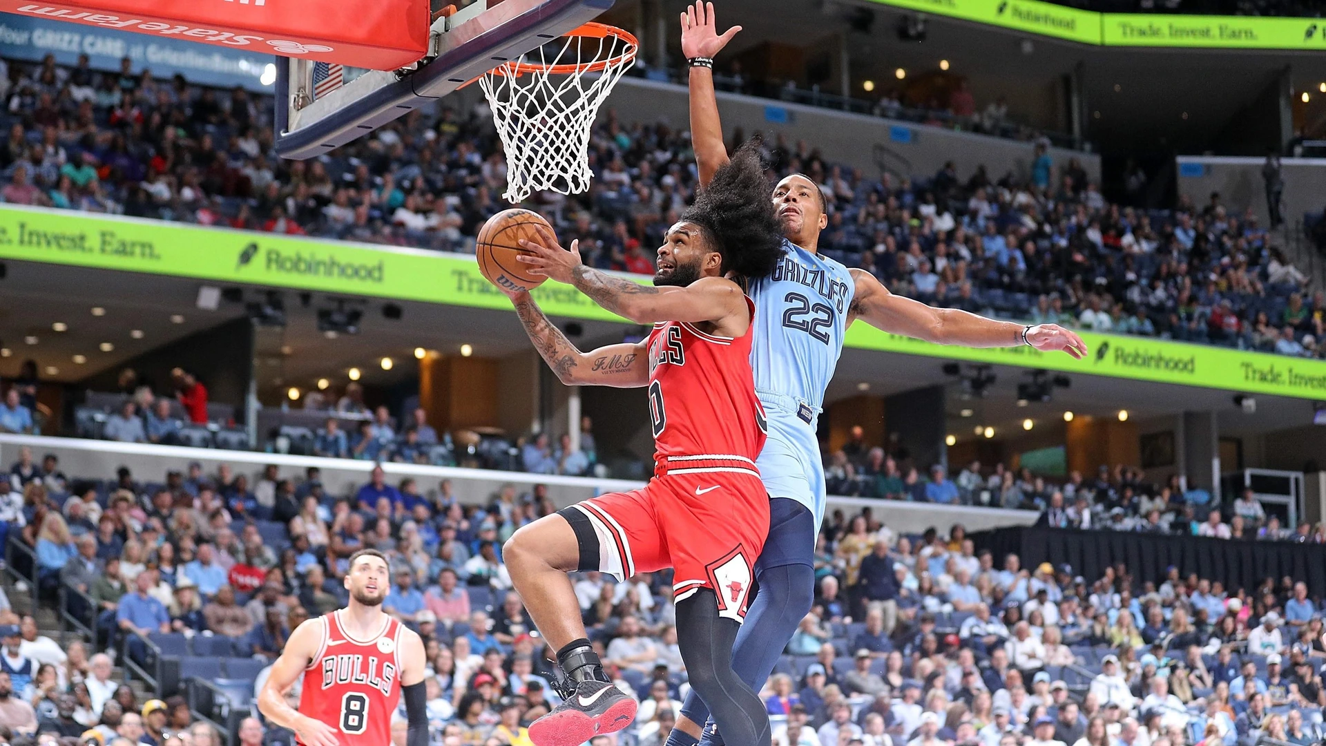 MEMPHIS, TENNESSEE - OCTOBER 28: Coby White #0 of the Chicago Bulls goes to the basket against Desmond Bane #22 of the Memphis Grizzlies during the second half at FedExForum on October 28, 2024 in Memphis, Tennessee.